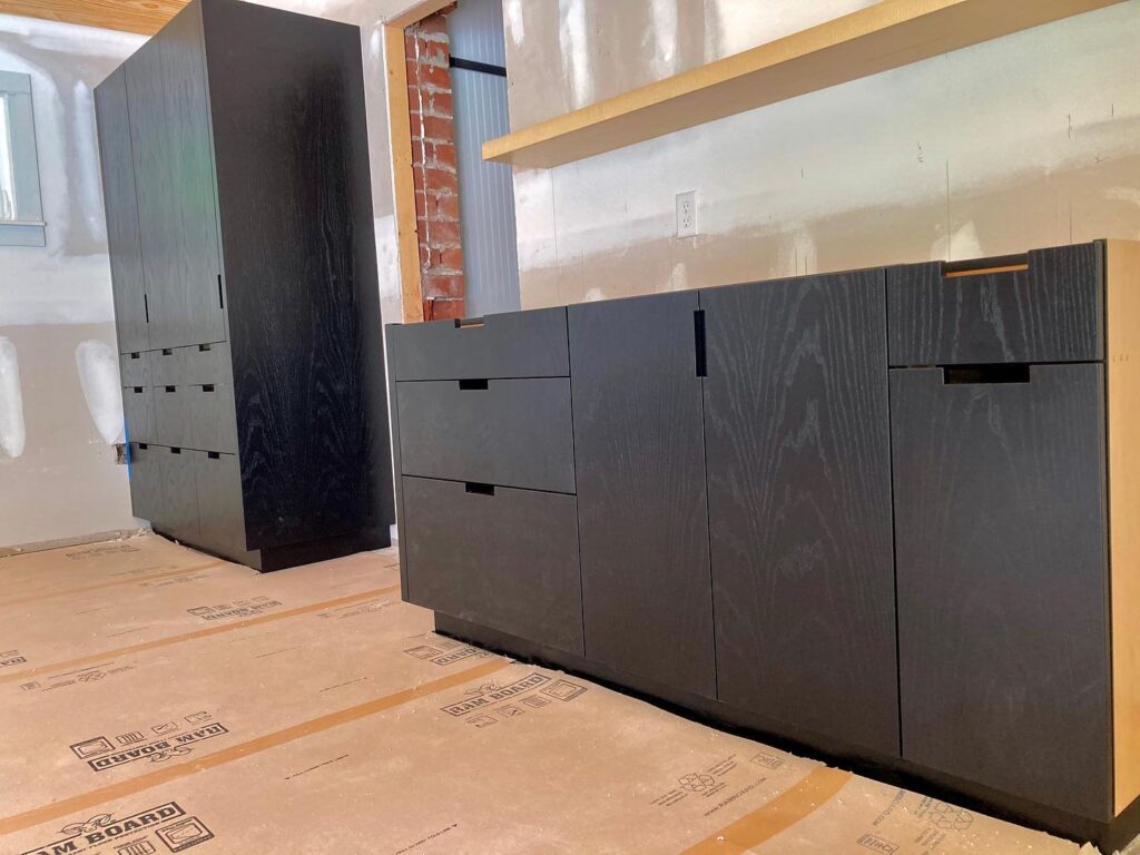 Black dyed ash, notched pulls. #customblackcabinets #strawwoodwork #murphybed