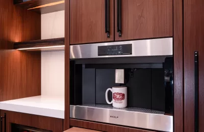 Wolf Coffee EC2450TE:S built in to walnut kitchen cabinets